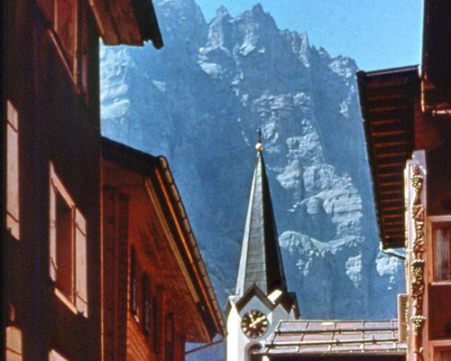 An exterior view of resort alongside the mountain.