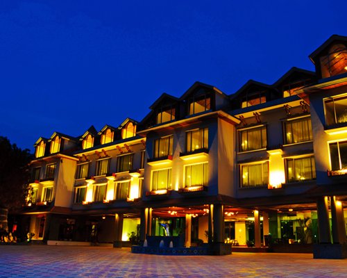 An exterior view of the Manali Resorts at night.