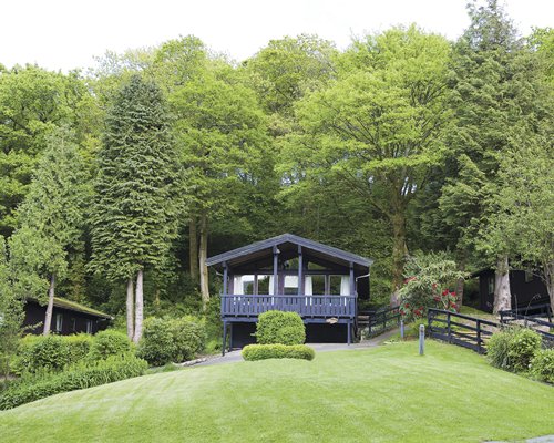 An exterior view of a resort unit surrounded by wooded area.