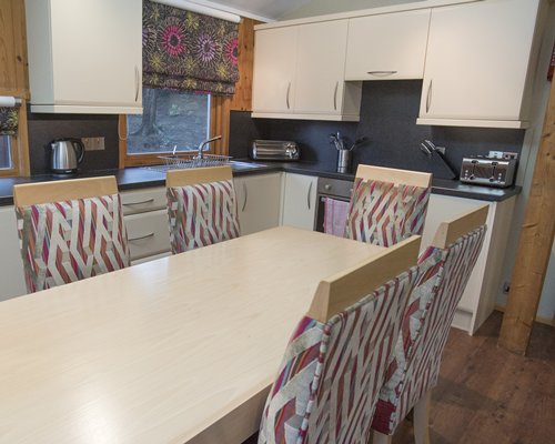 An open plan kitchen with dining area and outside view.