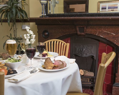 Indoor restaurant with a fireplace at Brockwood Hall.