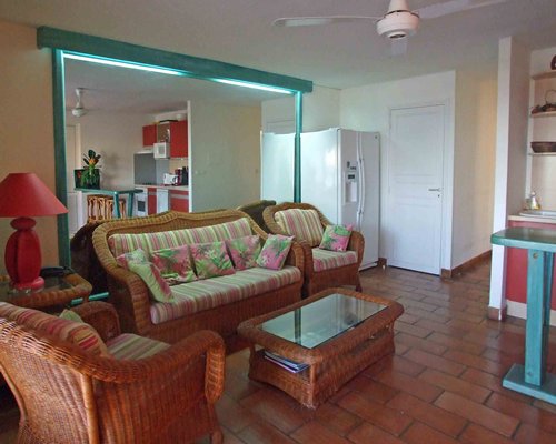 A well furnished living room with open plan kitchen.