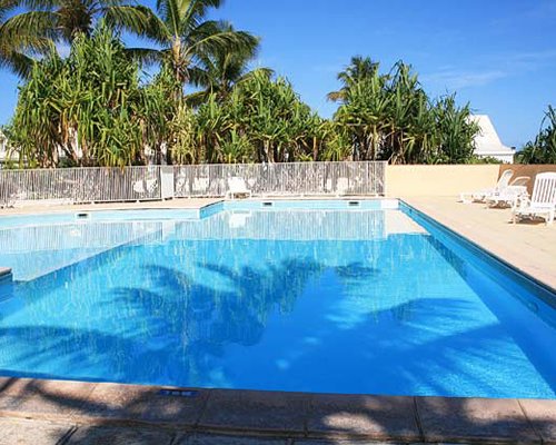 Outdoor swimming pool with chaise lounge chairs.