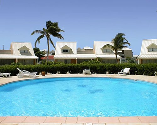 Outdoor swimming pool with chaise lounge chairs.