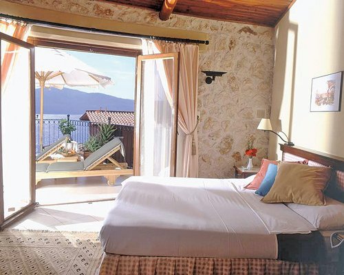 A well furnished bedroom with a double bed and an outside view.