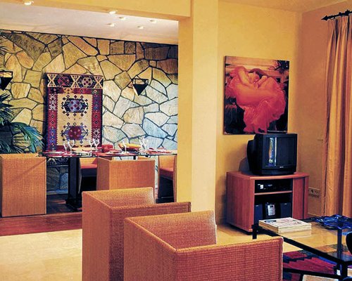 A living room with television alongside dining area.