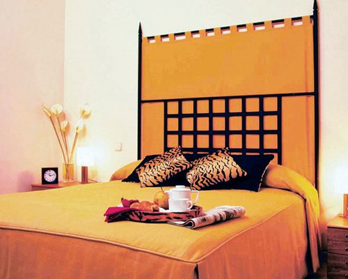 A well furnished bedroom with a double bed.