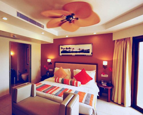 A well furnished bedroom with a double bed and an outside view.