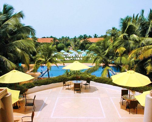 An outdoor dining area alongside the swimming pool.