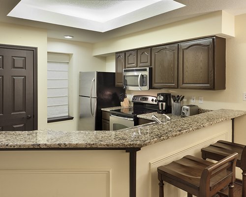 A well equipped kitchen and breakfast bar.