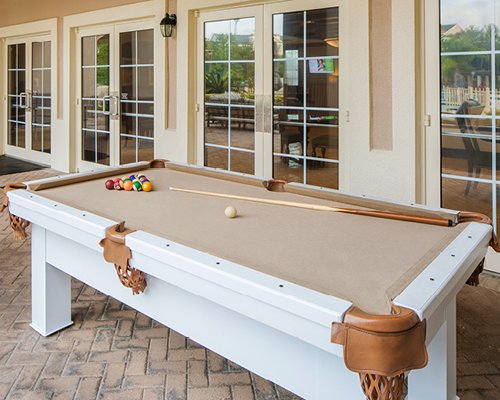 An outdoor recreation area with pool table.