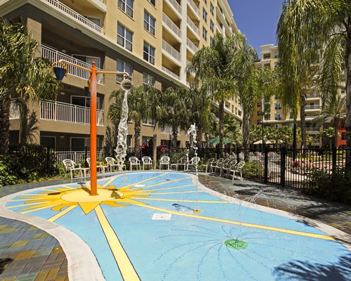 An outdoor playscape alongside multi story resort units.