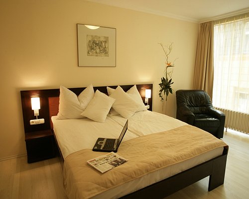 A well furnished bedroom with an outside view.