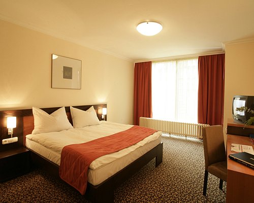 A well furnished bedroom with an outside view.