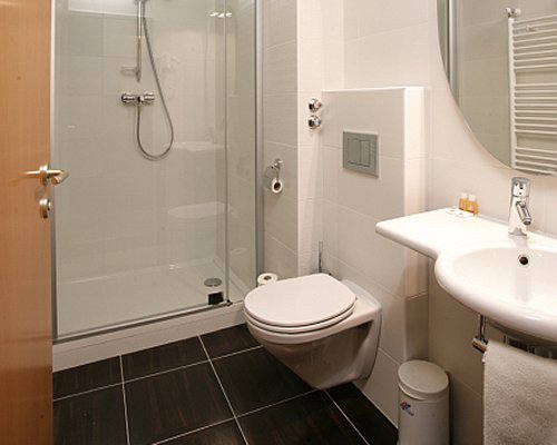 A bathroom with stand up shower and single sink vanity.