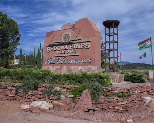 Signboard of Sedona Pines Resort with national flags.
