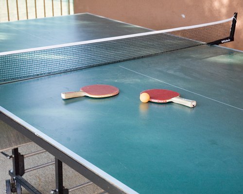 An indoor recreational room with a ping pong table.