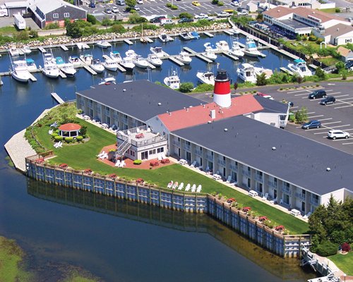 An aerial view of the resort with a parking lot alongside a marina.