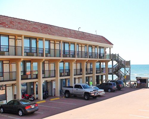 An exterior view of a resort unit alongside a parking lot.