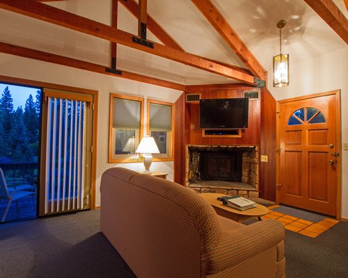 A well furnished living room with a television fireplace and an outside view.