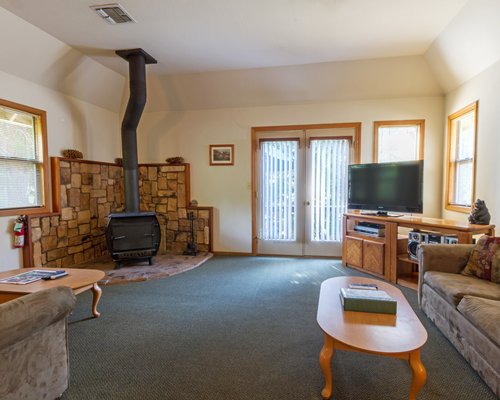 A well furnished living room with a television and a fireplace.