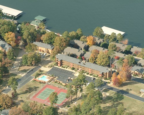 An aerial view of the resort properties surrounded by trees alongside the lake.