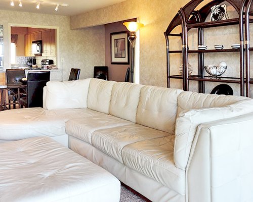 An open plan living room dining and kitchen area with a sleeper sofa.