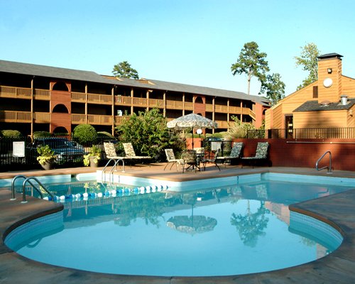 An outdoor swimming pool with chaise lounge chairs.