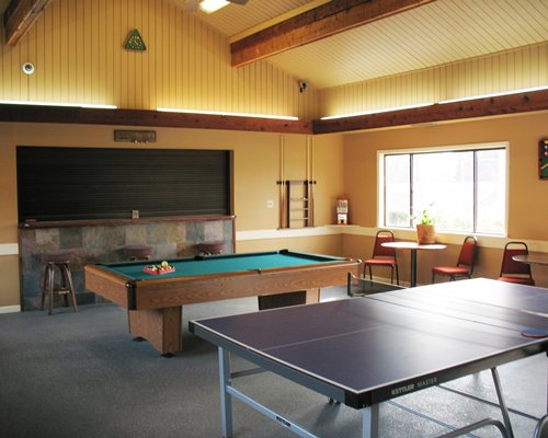 An indoor recreational area with pool table and ping pong.
