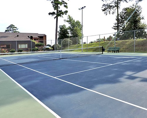 An outdoor tennis court alongside the resort units.