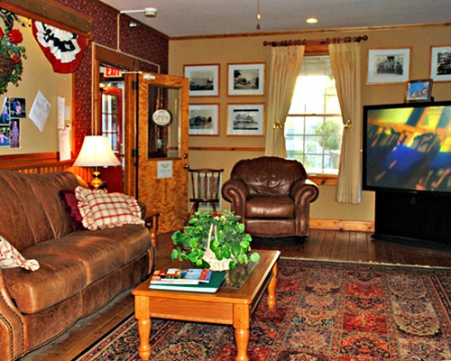 A well furnished living room with double pull out sofa television and an outside view.