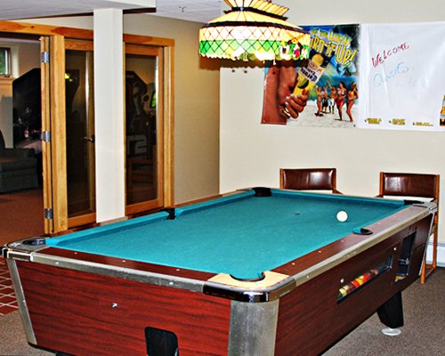 An indoor recreational room with pool table.