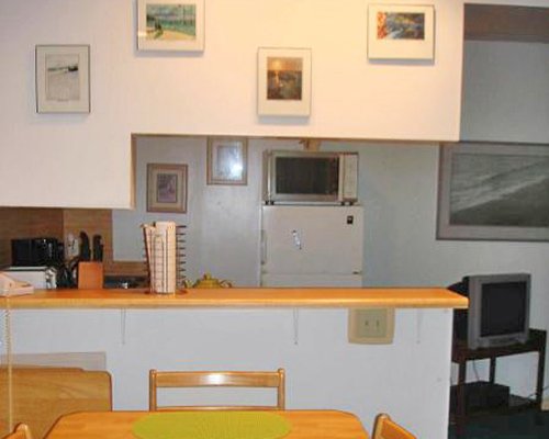 An open plan dining and kitchen area with a television.
