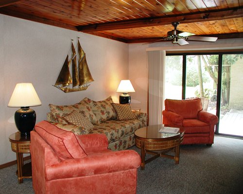 A well furnished living room with double pull out sofa and a patio.