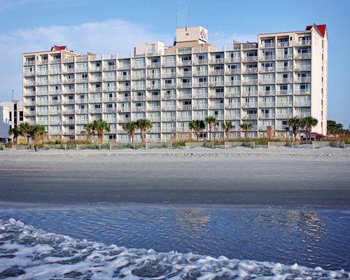 A beach view of multi story resort units.