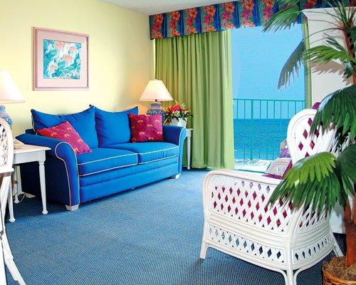 A well furnished living room with balcony and ocean view.
