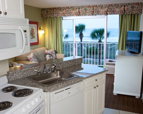 A well equipped kitchen with the beach view.