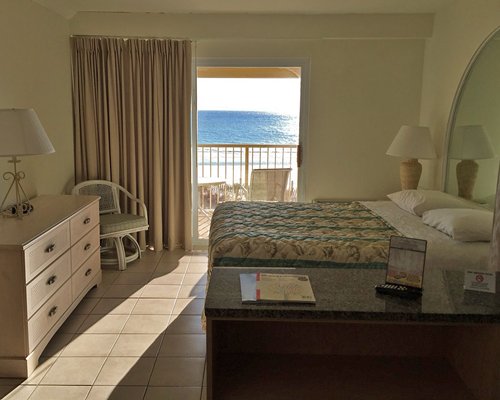 A well furnished bedroom with a balcony.