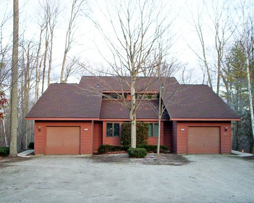 An exterior view of resort unit surrounded by woods.