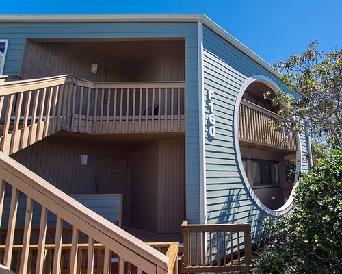 An exterior view of a resort unit with a staircase.