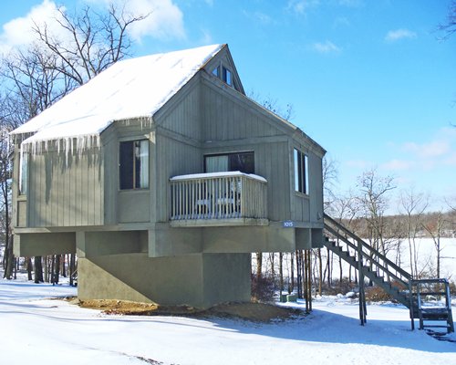 An exterior view of a resort unit covered in snow.