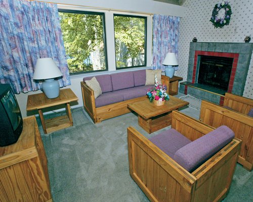 A well furnished living room with television fireplace and an outside view.