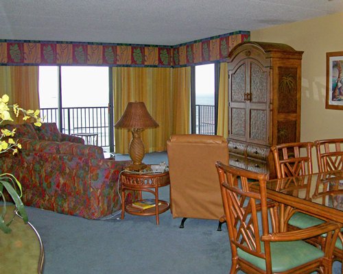An open plan living and dining area with a balcony.