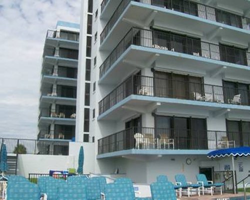 View of chaise lounge chairs alongside the multi story condo.
