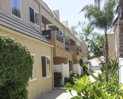 An exterior view of the Sand Pebbles resort and a pathway.
