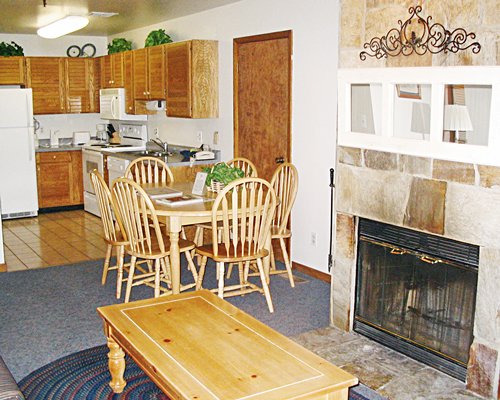 An open plan kitchen with dining area living room and fireplace.