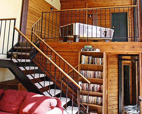 A staircase leading to an indoor balcony.