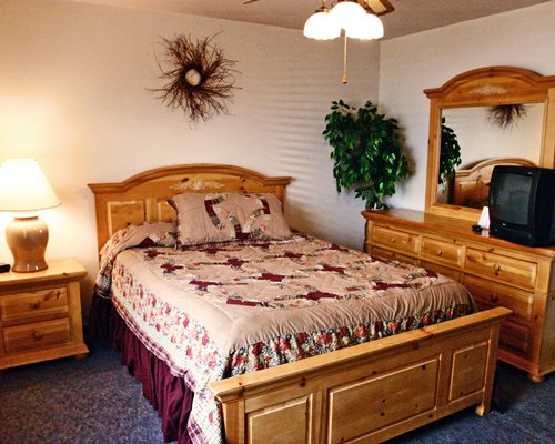 A well furnished bedroom with a television.