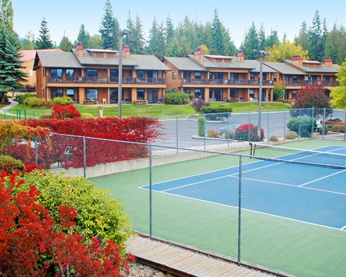 Outdoor tennis courts alongside resort units.