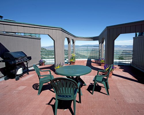 Picnic area with barbeque grill and an outside view.